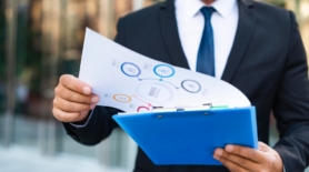 front-view-business-man-looking-charts_23-2148763828